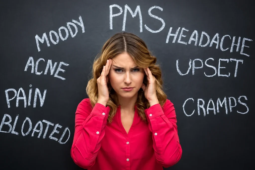 Woman experiencing common hormonal imbalance symptoms such as headache and mood changes