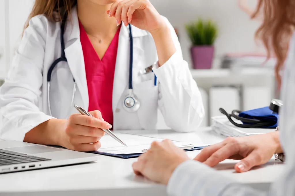 Woman discussing urinary incontinence symptoms with a doctor